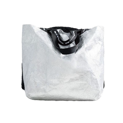 This image features a stylish tote bag, characterized by its large, open design with a sleek black handle. The tote is crafted from a textured white material that resembles faux fur, creating a chic and trendy appearance.